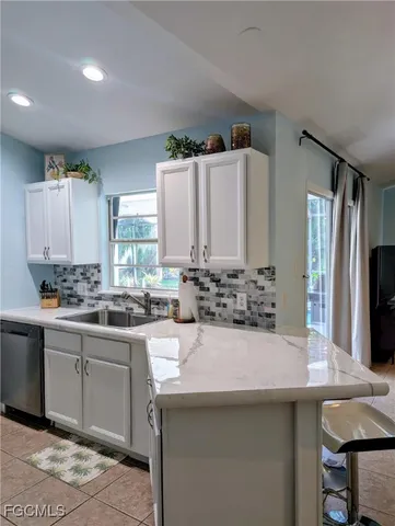 a kitchen with a sink and a refrigerator