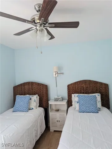 a bedroom with a bed and ceiling fan