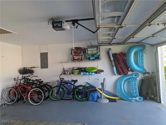 a view of a garage with a bike and a car