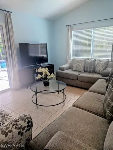 a living room with furniture and a large window