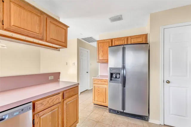a kitchen with a refrigerator and cabinets