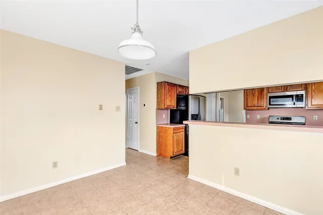 a view of living room with furniture and a refrigerator