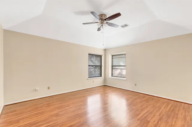 a view of a room with wooden floor and white walls