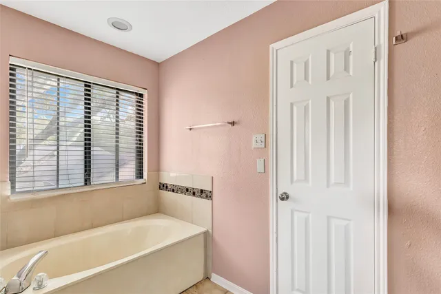 a bathroom with a bathtub and a shower