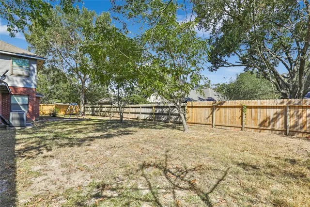 a view of backyard with large trees