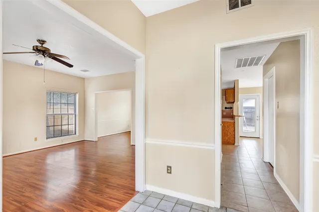 a view of a hallway with wooden floor and closet