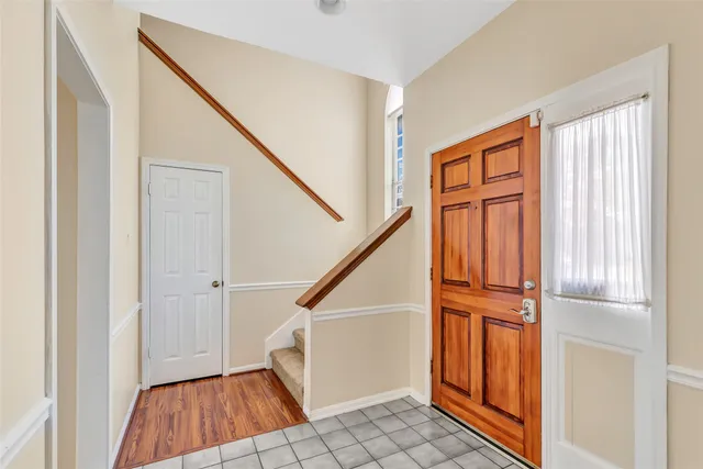 a view of entryway with stairs and wooden floor