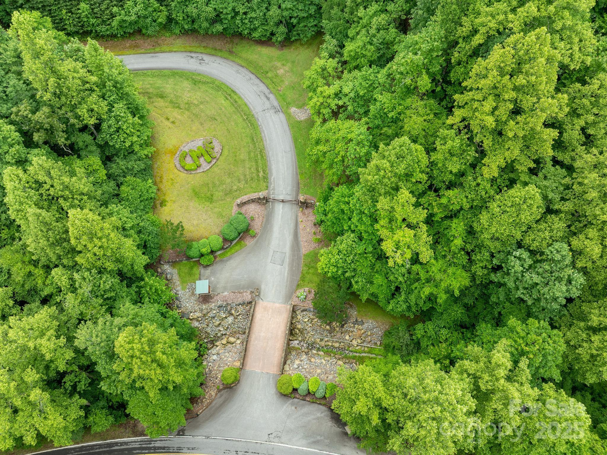 0 Wheel Team Trail, Unit 44 McGrady, NC 28649 - Photo 24 of 48 an aerial view of a house with a yard and trees all around