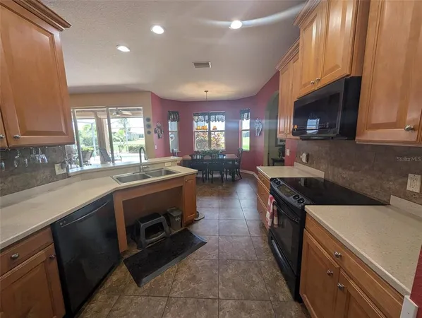 a kitchen with stainless steel appliances a stove sink microwave and cabinets