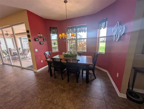 a view of a dining room with furniture and chandelier