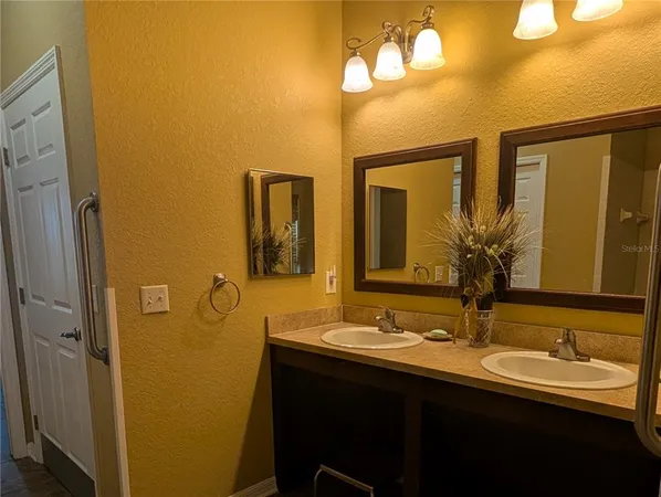 a bathroom with a double vanity sink and a mirror