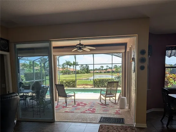 a living room with hardwood floor and a floor to ceiling window