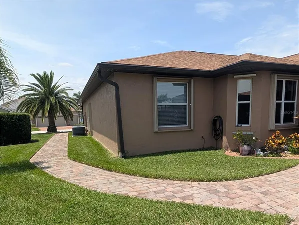 a front view of house with yard barbeque and outdoor seating