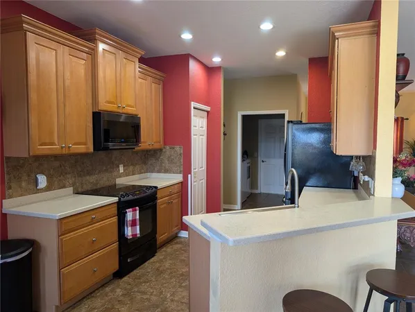 a kitchen with stainless steel appliances a stove microwave and refrigerator