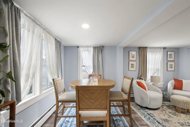 a dining room with furniture and wooden floor