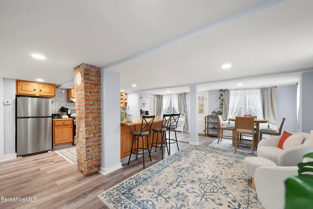 a living room with furniture and a kitchen view