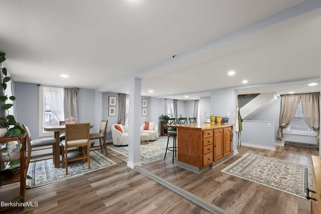 a living room with lots of furniture and kitchen view