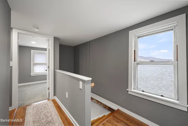 an entryway and a window with wooden floor