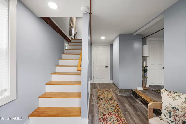 a view of bedroom with stairs and wooden floor
