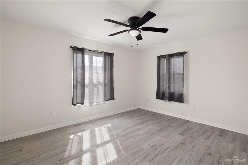 400 Taurus Street Mission, TX 78572 - Photo 13 of 18 a view of an empty room with wooden floor and a window
