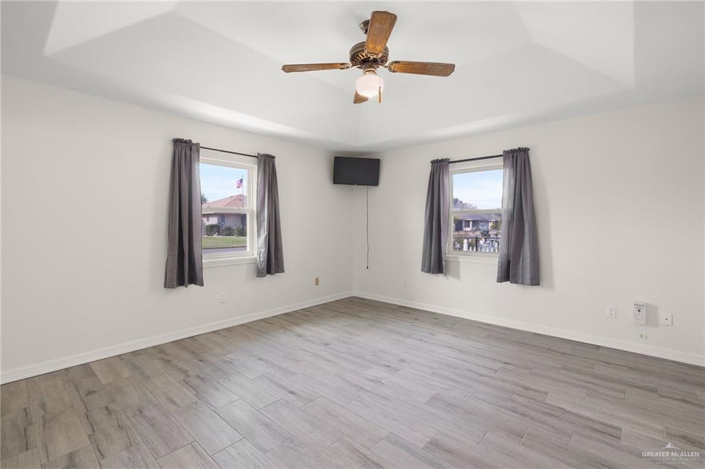 400 Taurus Street Mission, TX 78572 - Photo 15 of 18 an empty room with windows and fan