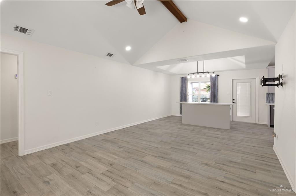 400 Taurus Street Mission, TX 78572 - Photo 4 of 18 wooden floor in an empty room with a window