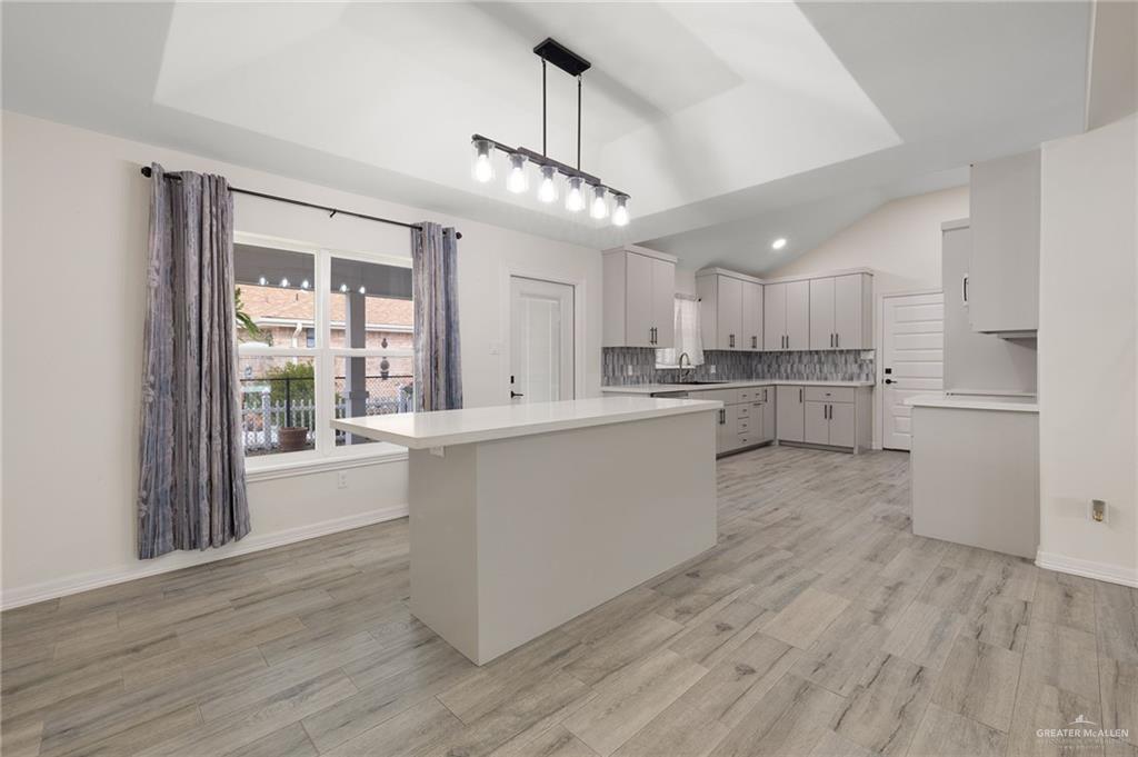 400 Taurus Street Mission, TX 78572 - Photo 7 of 18 a large kitchen with cabinets wooden floor and stainless steel appliances