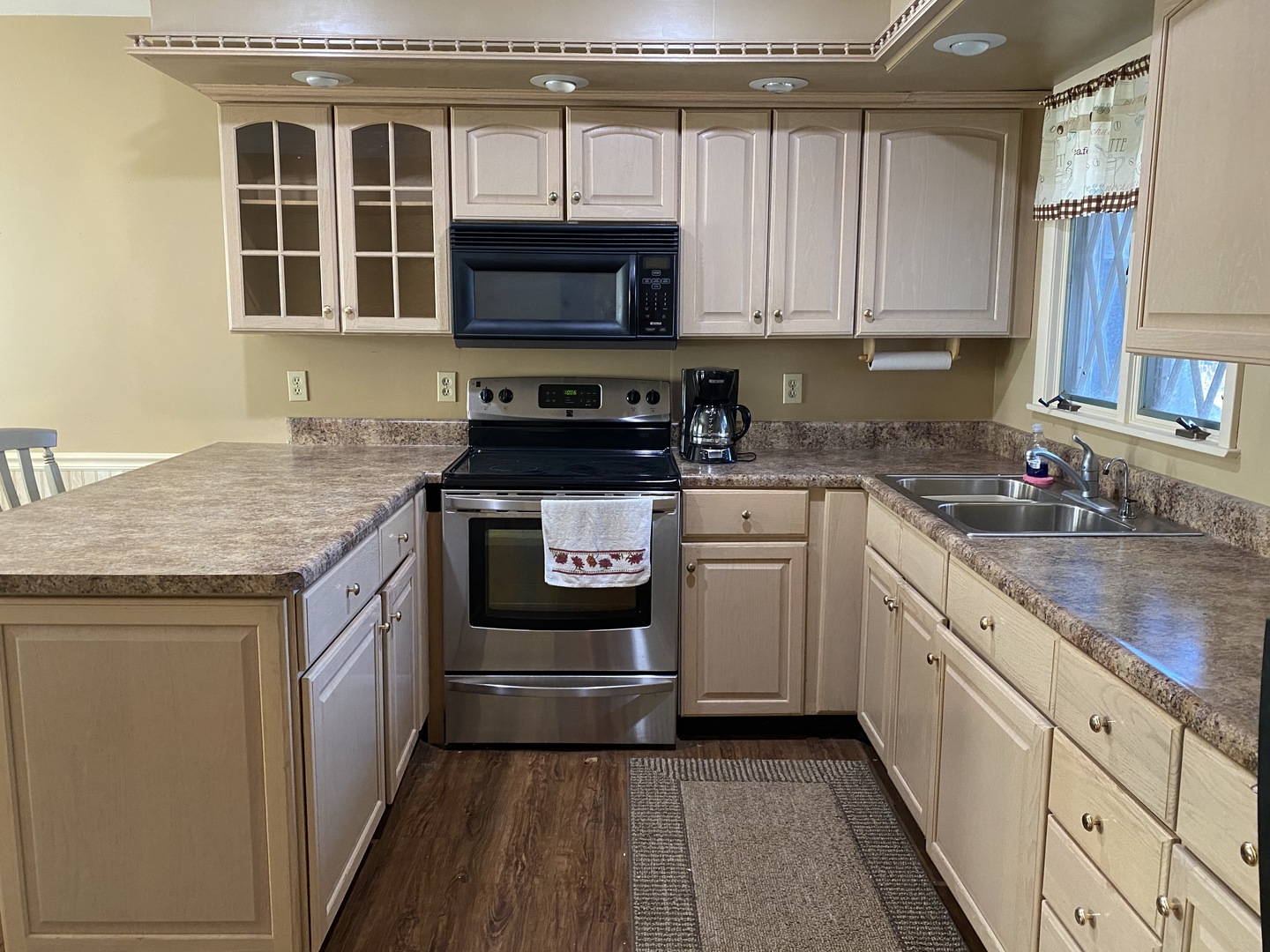 227 East Caroline Street Spring Valley, IL 61362 - Photo 8 of 16 a kitchen with stainless steel appliances granite countertop a stove microwave and cabinets