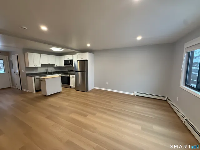 a view of a kitchen with a stove cabinets and wooden floor