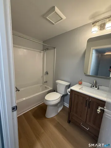 a bathroom with a sink toilet a mirror and shower