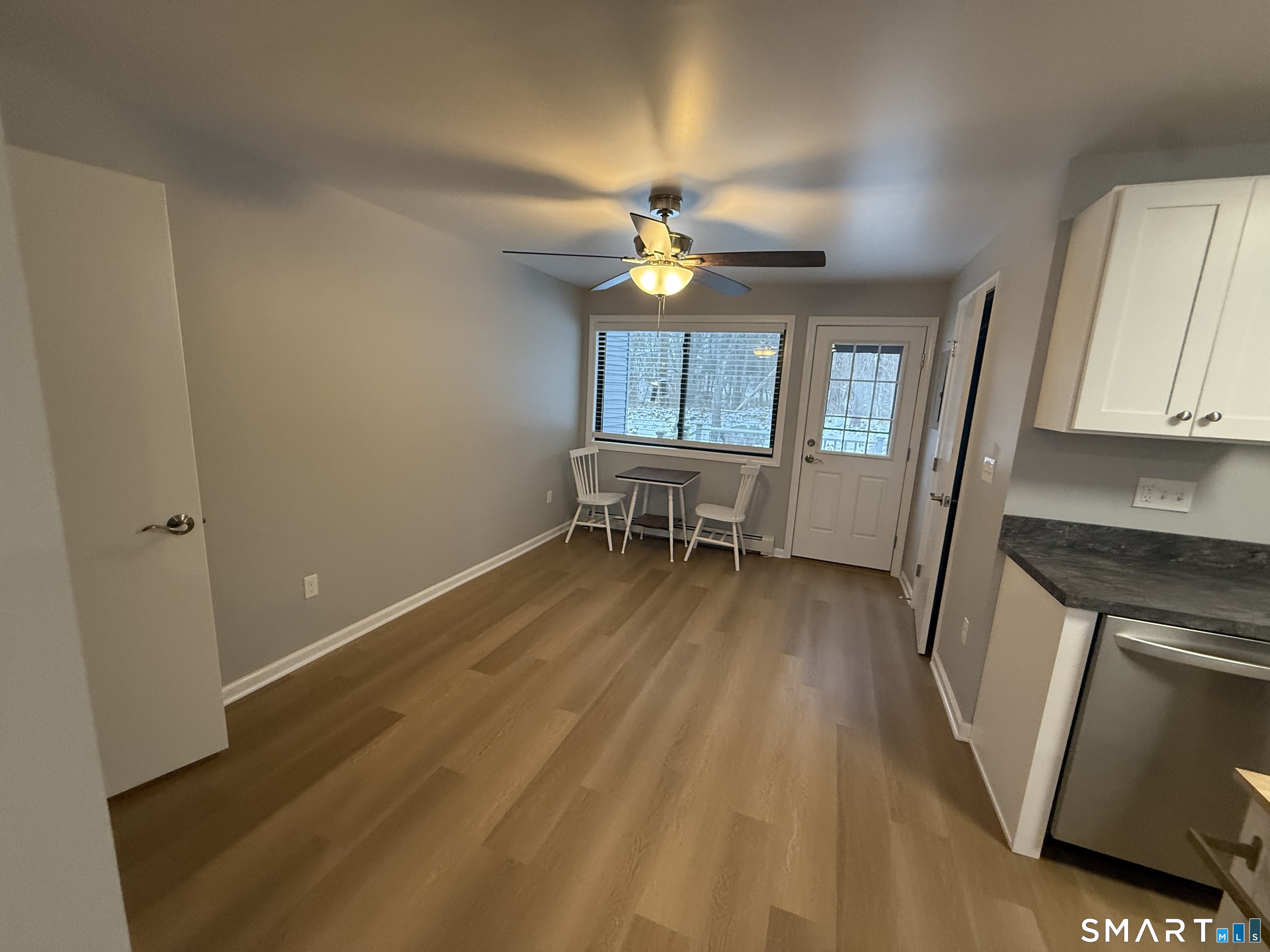 292 Meridian Street, Unit K Groton, CT 06340 - Photo 6 of 20 wooden floor in an empty room with a window