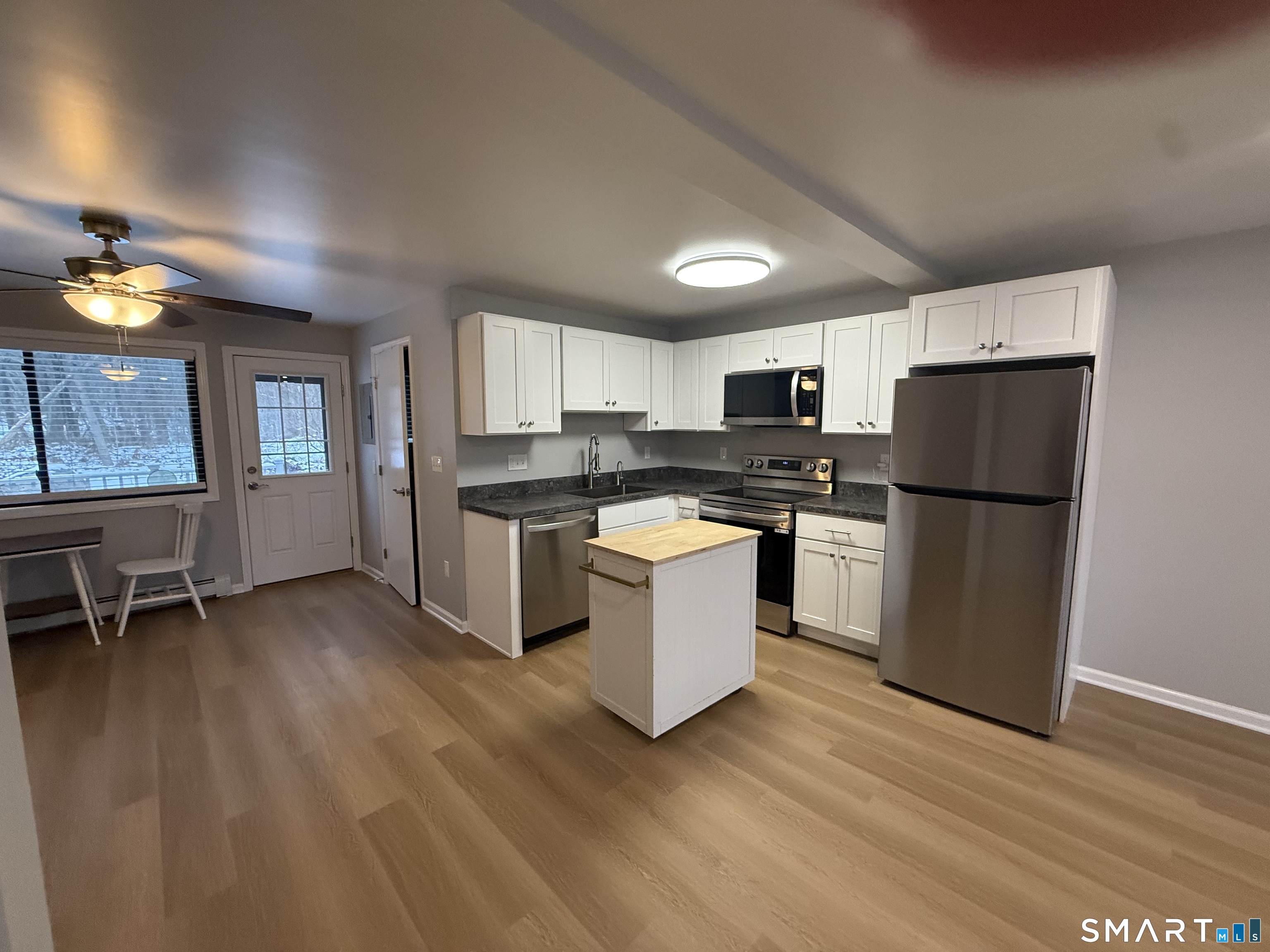 292 Meridian Street, Unit K Groton, CT 06340 - Photo 10 of 20 a kitchen with a refrigerator and a stove top oven