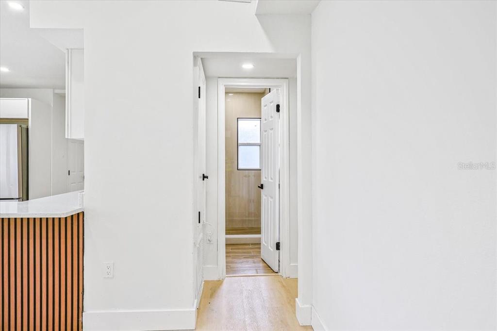 4061 Ferrow Street Orlando, FL 32811 - Photo 13 of 31 a view of a hallway with wooden floor