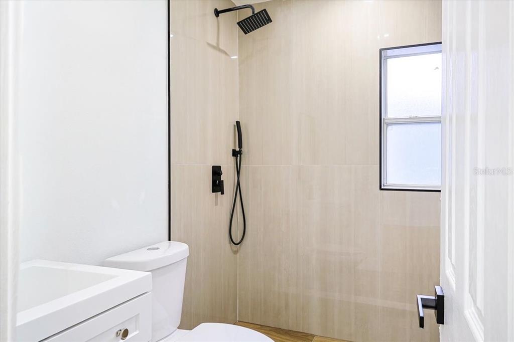 4061 Ferrow Street Orlando, FL 32811 - Photo 14 of 31 a bathroom with a toilet and shower