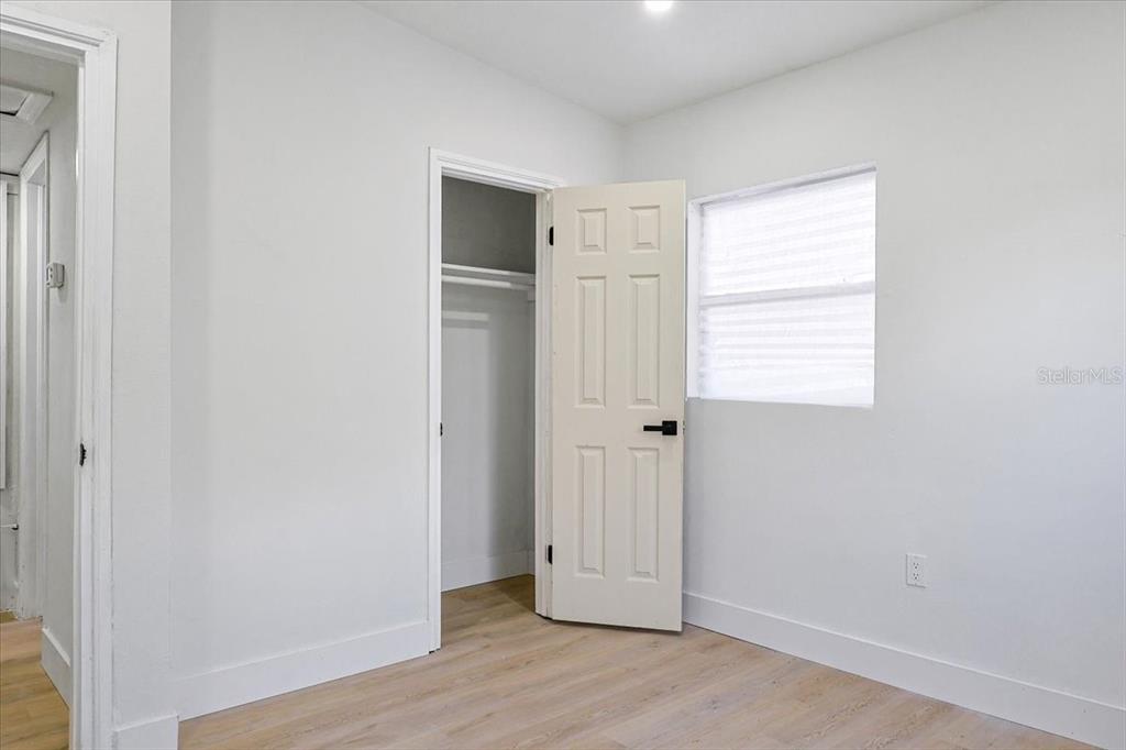 4061 Ferrow Street Orlando, FL 32811 - Photo 21 of 31 a view of an empty room with wooden floor and a window