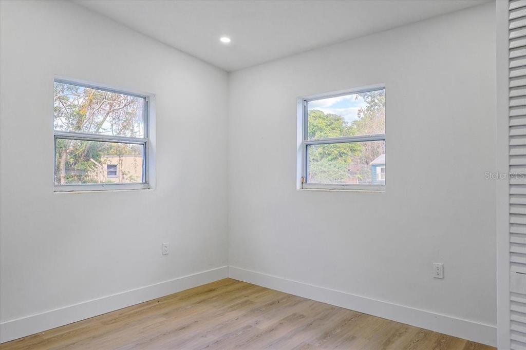 4061 Ferrow Street Orlando, FL 32811 - Photo 24 of 31 a view of an empty room with wooden floor and a window
