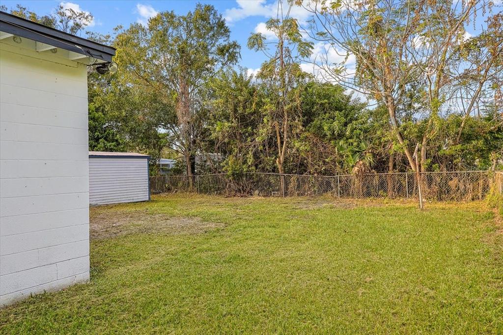 4061 Ferrow Street Orlando, FL 32811 - Photo 26 of 31 a backyard of a house with large trees