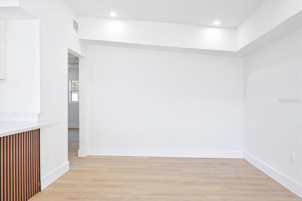 4061 Ferrow Street Orlando, FL 32811 - Photo 6 of 31 a view of an empty room with wooden floor