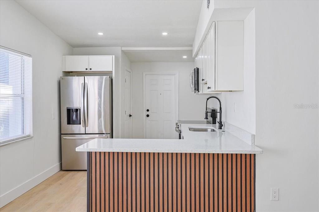 4061 Ferrow Street Orlando, FL 32811 - Photo 7 of 31 a kitchen with stainless steel appliances a sink and cabinets