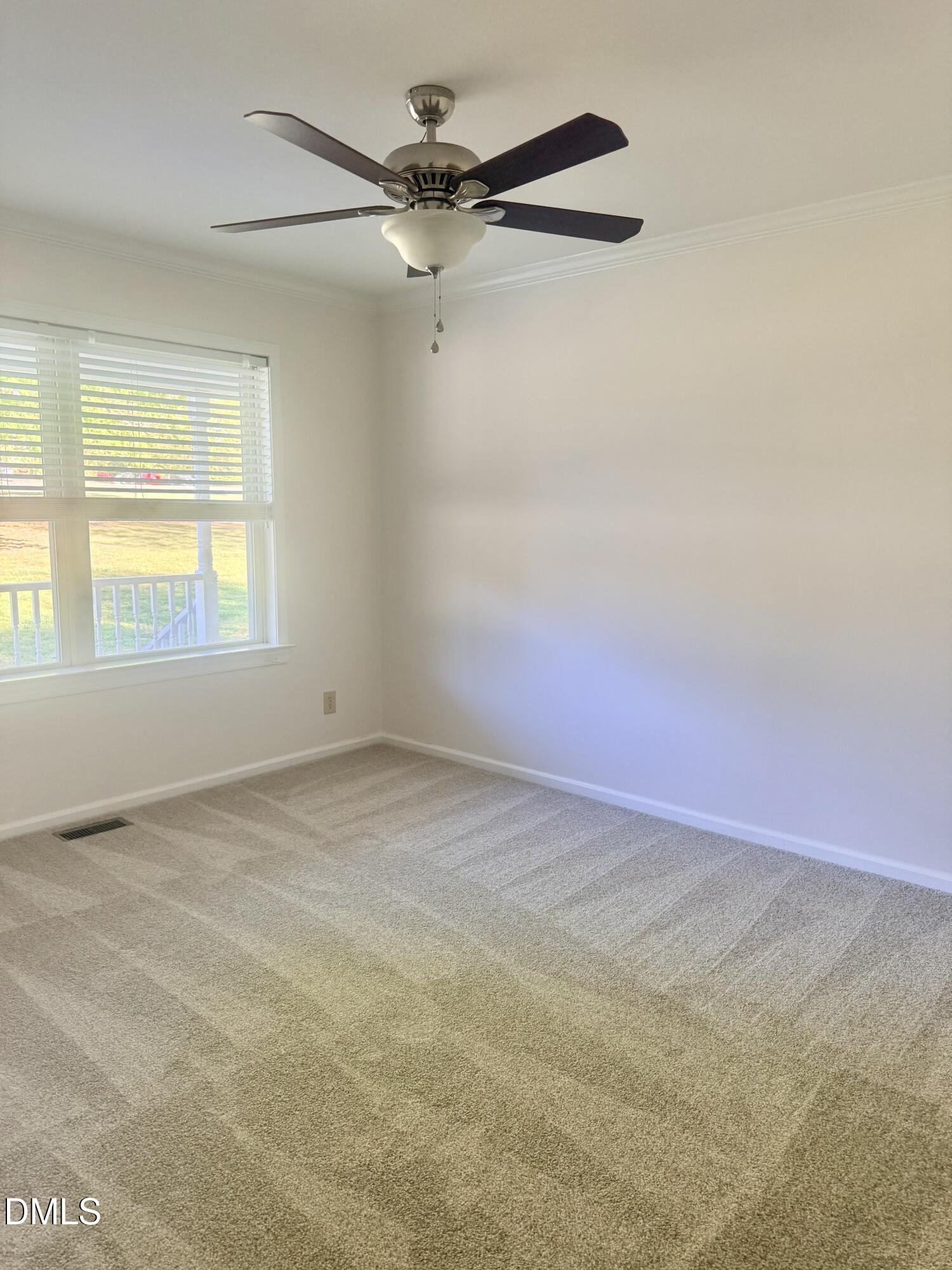 2429 Halifax Road Roxboro, NC 27573 - Photo 38 of 54 an empty room with a window and a fan