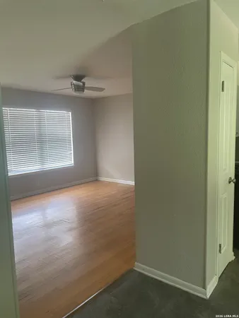 an empty room with a empty space and windows