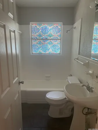 a white toilet sitting next to a bathroom sink