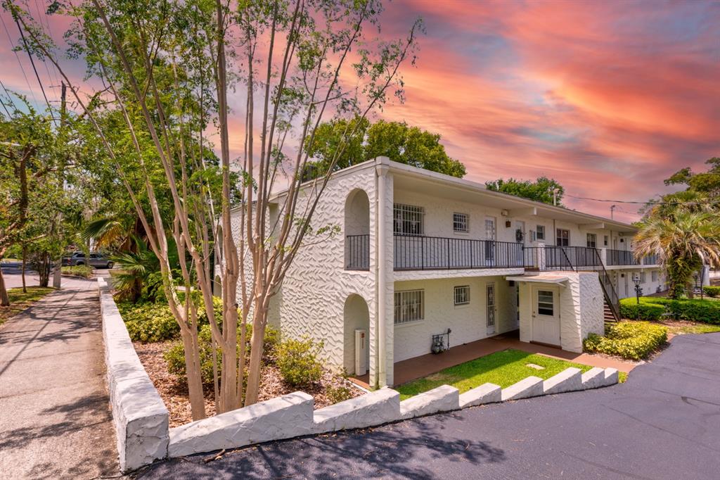 145 East 6th Avenue, Unit 8 Mount Dora, FL 32757 - Photo 1 of 1 a view of a white house with a large trees and large tree