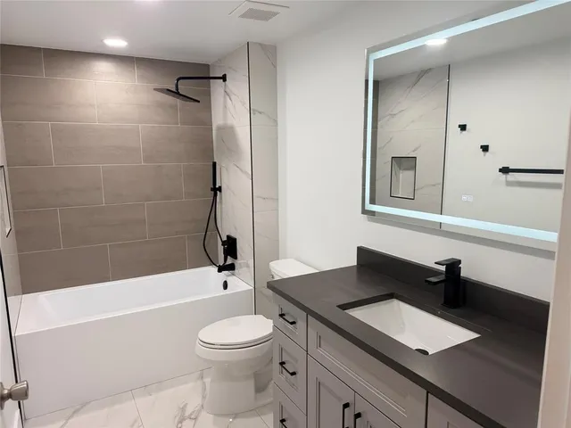a bathroom with a sink a toilet and a bathtub