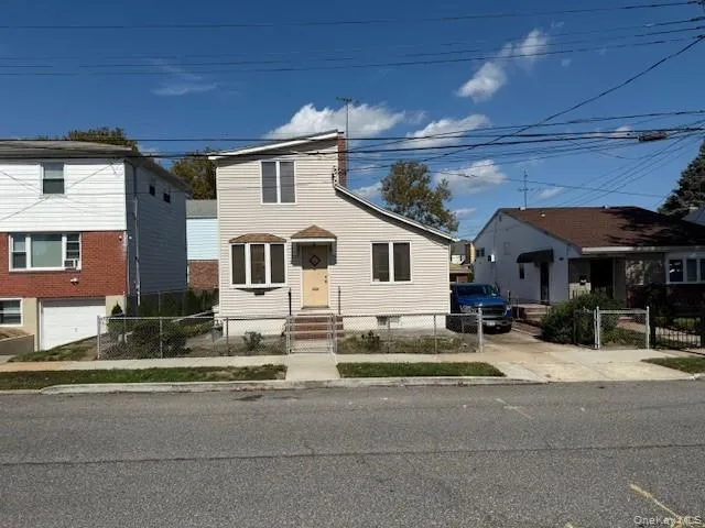 a view of a white house with a outdoor space