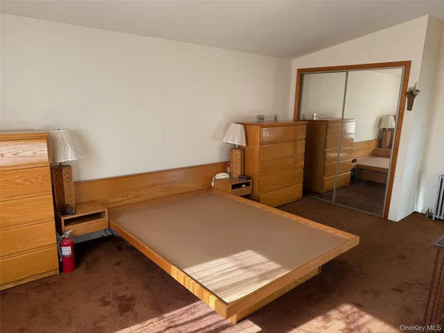 a room with a bed and cabinets