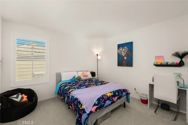 a bedroom with a bed and a chair