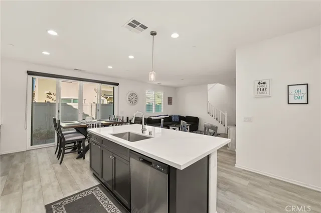 a kitchen with a table chairs and a refrigerator