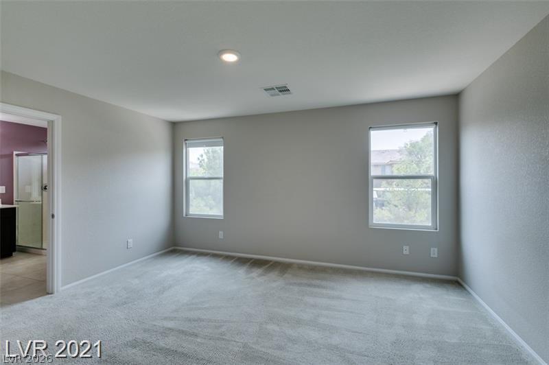 5475 Ordesa Valley Road Las Vegas, NV 89148 - Photo 13 of 35 Well-lit and spacious, this bedroom offers plush carpeting and dual windows overlooking the neighborhood.