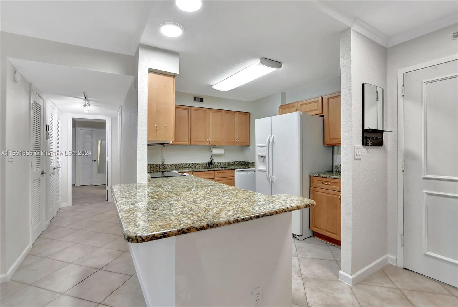 1000 Spanish River Road, Unit 2F Boca Raton, FL 33432 - Photo 6 of 53 a kitchen with stainless steel appliances granite countertop a refrigerator and a sink